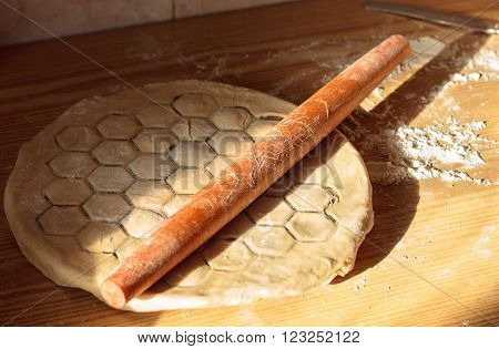 Cook hands sculpt dumplings with minced meat closeup