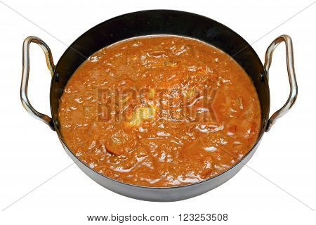 Balti butter chicken in a karahi bowl with an isolated white background and clipping path