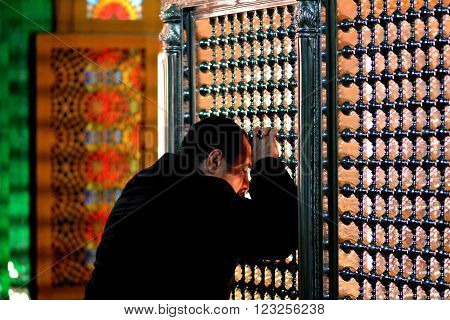 BAKU, AZERBAIJAN - JANUARY 27 2014 
The tomb of Ukeyma Khanum in Bibi-heybat Mosque. Worshipper in the most significant mosque in Azerbaijan, just outside the capital, Baku