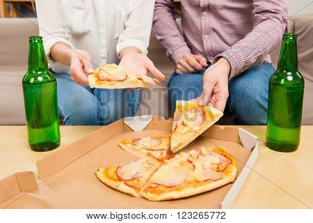 Close Up Photo Of Man And Woman Taking Pizza From Box