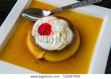 Caramel Custard, Custard Pudding with Cream on a white plate.