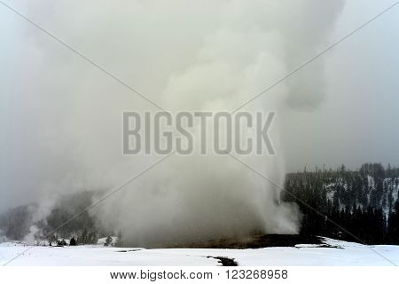 Old Faithful Geothermal geyser in winter Yellowstone National Park