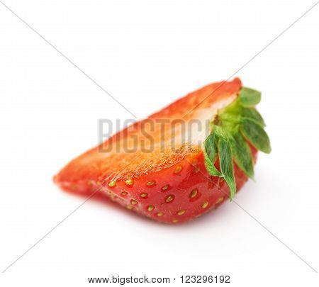 Slice cross-section of a single ripe red strawberry isolated over the white background