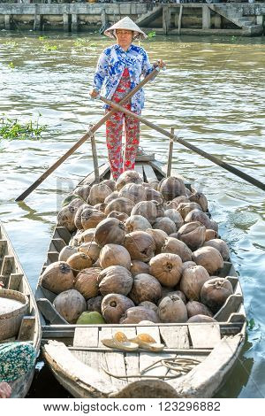 Soc Trang, Vietnam - February 2nd, 2016: Farmers are selling boating dock on the river dried coconut countryside in the afternoon at the floating market Soc Trang, Vietnam