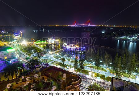 Can Tho, Vietnam - February 3rd, 2016: night city Can Tho Ninh Kieu wharf river with many sparkling lights, so far as Can Tho Bridge shines at night makes more lively night scene in Can Tho, Vietnam