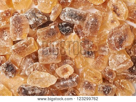 Surface coated with multiple large brown rock sugar crystals as a background composition
** Note: Shallow depth of field