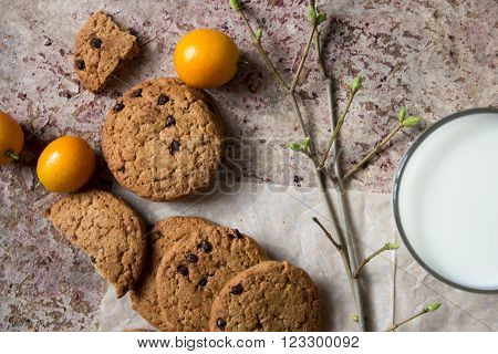 oatmeal cookies on the paper, milk in the glass cup, lemongrass