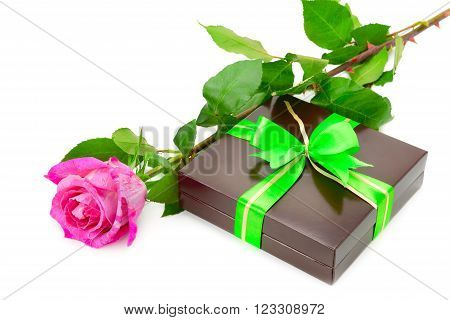 Present and rose isolated on white background