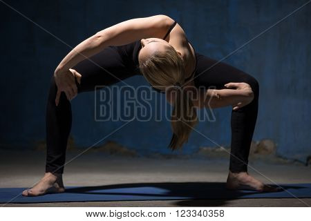Beautiful Yoga Woman Standing In Twisting Sumo Squat Pose