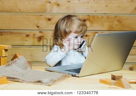 Small Boy With Computer And Phone