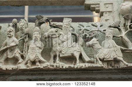 Stone sculptures with life of ancient sages on carved wall of Wat Pho temple Bangkok. Buddhist temple complex founded in 16th century