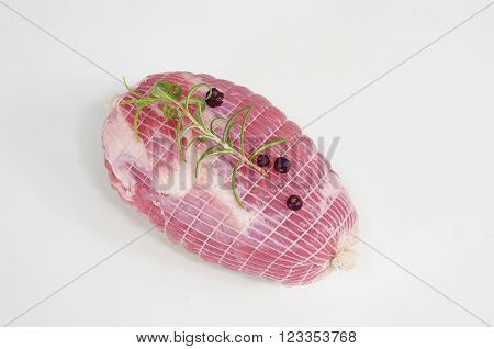 raw ham with rosemary and laurel in dish