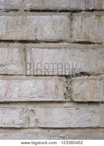 Grey textured background closeup. Gray old brick wall