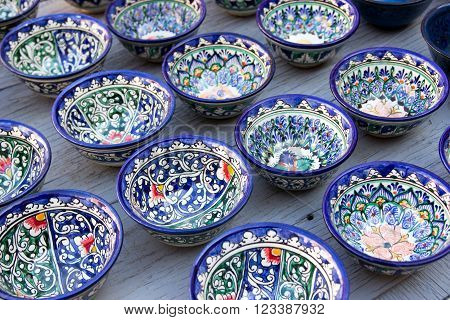 Rows of cups with traditional uzbekistan ornament on a street market of Bukhara Uzbekistan Central Asia. Silk Road