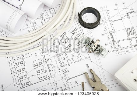 Architecture plan and rolls of blueprints with cabel and plug. Building concept