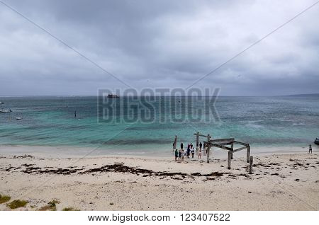 HAMELIN BAY,WA,AUSTRALIA-JANUARY 17,2016: Tourists and old jetty ruins on the turquoise Indian Ocean coast line under stormy skies in Hamelin Bay, Western Australia.