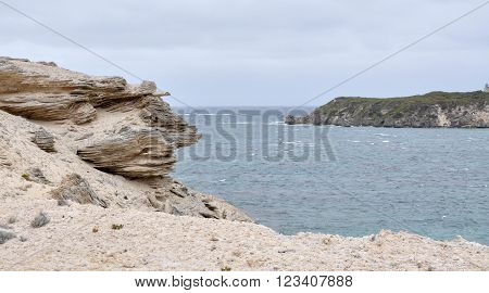 Limestone edges at White Cliff Point with Indian Ocean seascape under stormy skies in Hamelin Bay, Western Australia.