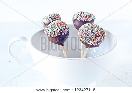 Small cupcake with chocolate in the shape of Chupa Chups decorated with sugaritaly