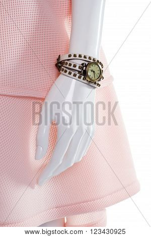 Classic watch on female mannequin. Female mannequin's arm with watch. Vintage watch with leather strap. Round watch with white strap.