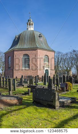SAPPEMEER, NETHERLANDS - MARCH 26, 2016: Old church Koepelkerk and graveyard in Sappemeer, Netherlands