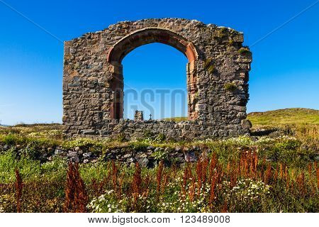 Arch of ruined chapel or church on Llanddwyn Island a peninsula on Anglesey. Newborough Anglesey Wales United Kingdom.