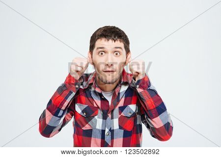 Man making a silly monkey face isolated on a white background