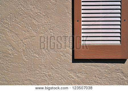 Simple horizontal shutter on exterior stucco wall