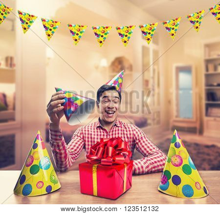 Man playing with Birthday hats
