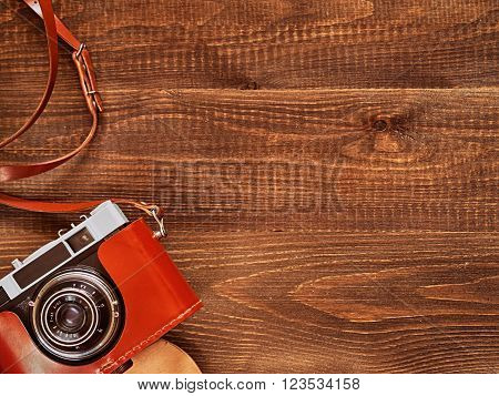 top view image of vintage old camera on wooden table background. Flat lay
