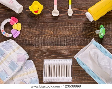 Baby Essentials On Dark Wooden Table With Copy Space