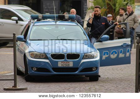 San Remo Italy - March 20 2016: Italian Policeman with a BMW car in the Streets of San Remo. City on the Mediterranean Coast of western Liguria in north-western Italy
