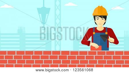 Bricklayer with spatula and brick.