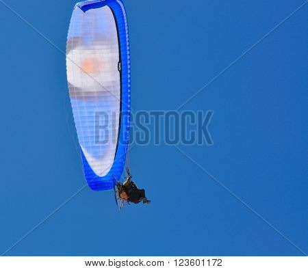 LANCELIN,WA,AUSTRALIA-SEPTEMBER 28,2015: Power-parachute with chair and rider with a clear blue sky background in Lancelin, Western Australia.