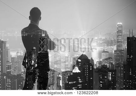 Photo of stylish adult businessman wearing trendy suit and looking city. Double exposure, panoramic view contemporary City background.