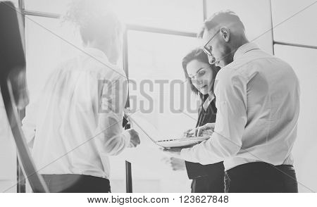 Business team work process. Photo professional crew working with new startup project. Project managers meeting. Analyze business plans laptop. Blurred background, film effect, black white.
