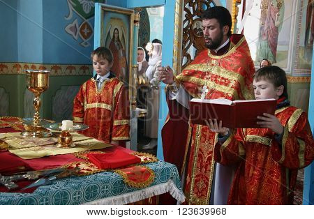LUTSK UKRAINE - NOVEMBER 02 - Orthodox priest and little sextons during holiday prayers in Lutsk on November 02 2008.