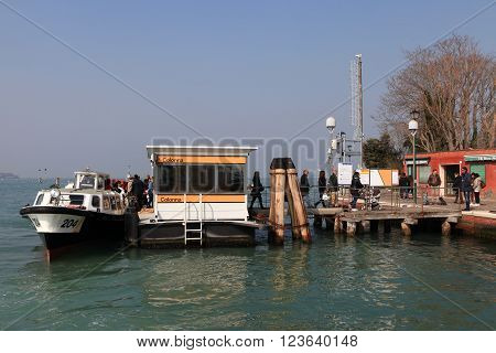Venice, Italy - March 17, 2016: Vaporetto (water bus) at Venice canal. Vaporettos are a traditional, flat-bottomed Venetian motor boat, well suited to the conditions of the Venetian lagoon