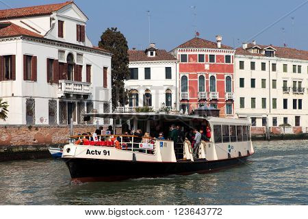 Venice, Italy - March 17, 2016: Vaporetto (water bus) at Venice canal. Vaporettos are a traditional, flat-bottomed Venetian motor boat, well suited to the conditions of the Venetian lagoon