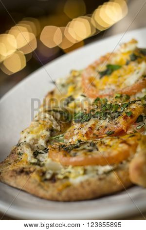 Personal size flatbread authentic margherita pizza with fresh tomatoes