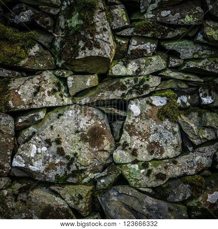 Background Texture Detail Of An Old Dry Stone Wall In Scotland