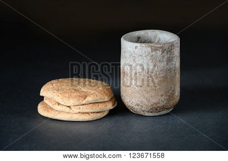 Bread and cup of wine as symbols of Communion on table