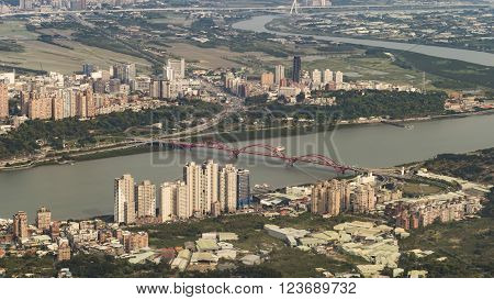 Scenery of Tamsui river with famous Guandu Bridge far away in Tamsui, New Taipei City, Taiwan