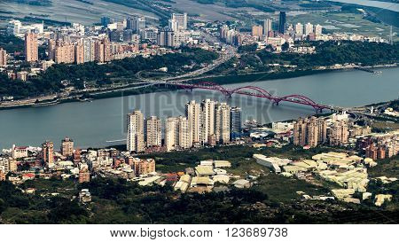 Scenery of Tamsui river with famous Guandu Bridge far away in Tamsui, New Taipei City, Taiwan
