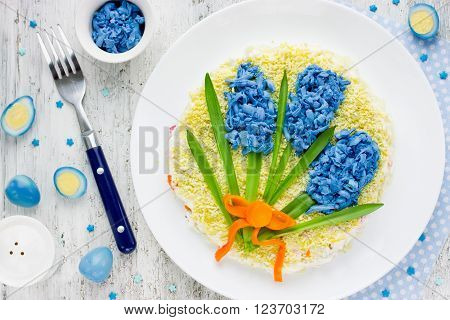 Easter festive salad Spring flowers of blue eggs. Fun art idea for holiday party food. Beautiful salad for gift on Mother's Day to mom top view