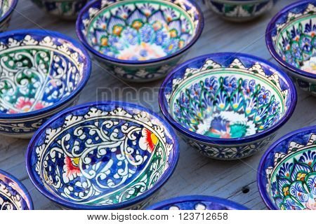 Rows of cups with traditional uzbekistan ornament on a street market of Bukhara Uzbekistan Central Asia. Silk Road