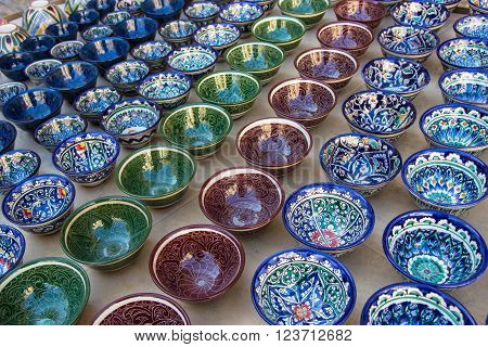 Rows of cups with traditional uzbekistan ornament on a street market of Bukhara Uzbekistan Central Asia. Silk Road