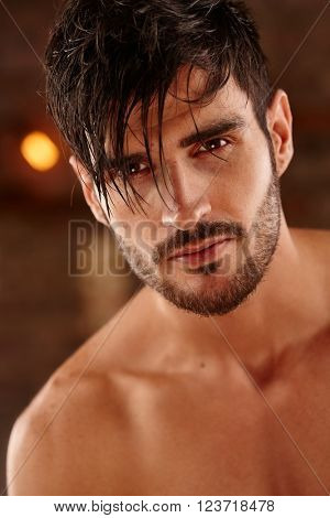 Closeup portrait of handsome young man with bare chest.