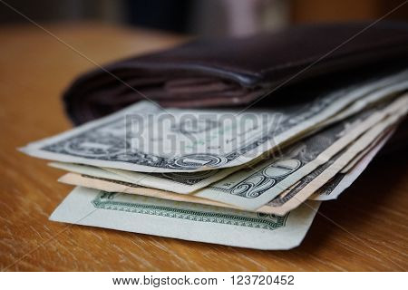 Detail of the American money (USD, US, US dollars), bank notes inserted in the leather wallet