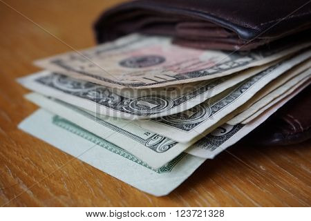 Detail of the American money (USD, US, US dollars), bank notes inserted in the leather wallet
