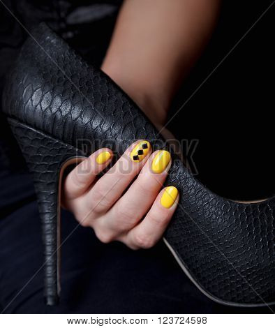 Close-up of extravagant yellow nails on a stiletto
